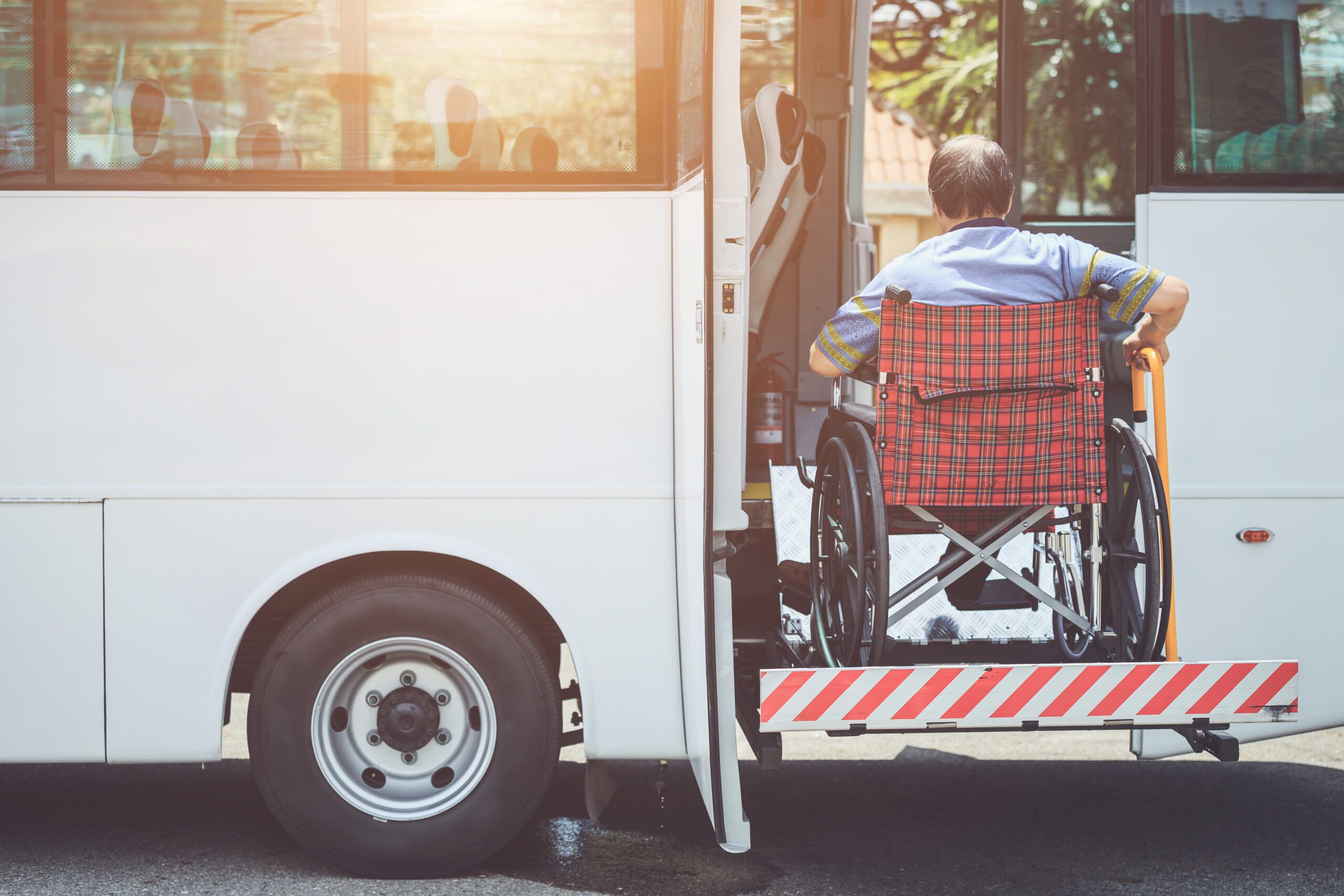 Wheelchair bound individual entering a hassle free transportation bus
